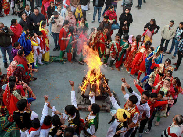Girls in traditional attire dance around a bonfire as they celebrate Lohri festival in Jammu. Girls in traditional attire dance around a bonfire as they celebrate Lohri festival in Jammu.