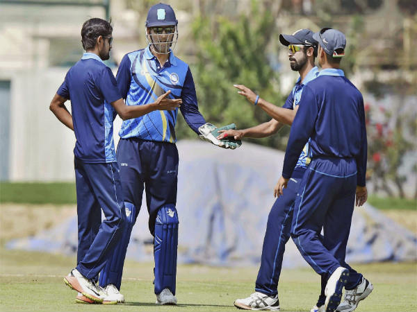 MS Dhoni (centre) celebrates with Jharkhand teammates MS Dhoni (centre) celebrates with Jharkhand teammates