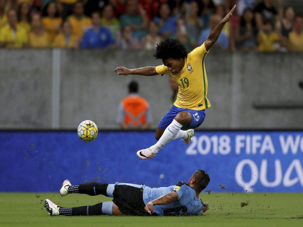 File photo: Brazil's Willian (top) against Uruguayan defender File photo: Brazil's Willian (top) against Uruguayan defender