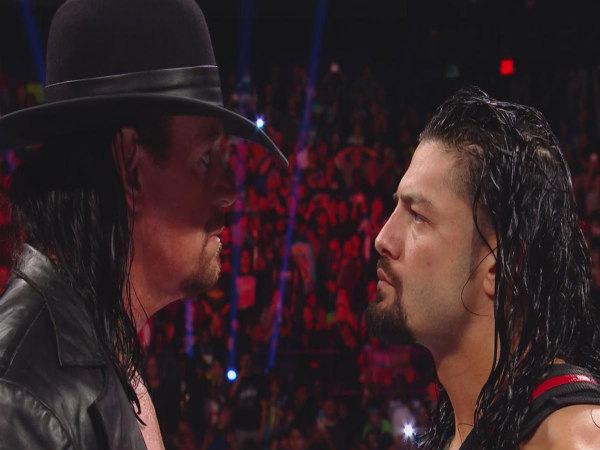 The Undertaker (left) and Roman Reigns (Image courtesy: wwe.com) The Undertaker (left) and Roman Reigns (Image courtesy: wwe.com)