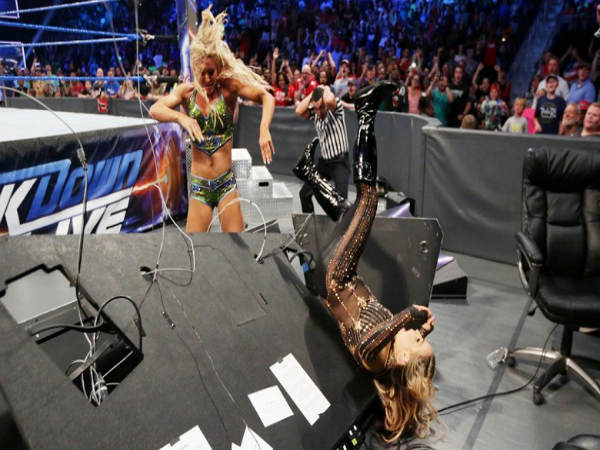 Charlotte (left) sending Natalya through a table (Image courtesy: wwe.com) Charlotte (left) sending Natalya through a table (Image courtesy: wwe.com)
