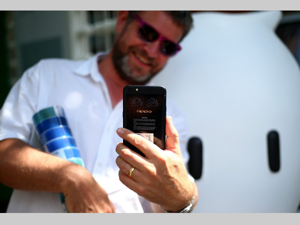 A fan takes a selfie with OPPO F3 phone at The Oval A fan takes a selfie with OPPO F3 phone at The Oval