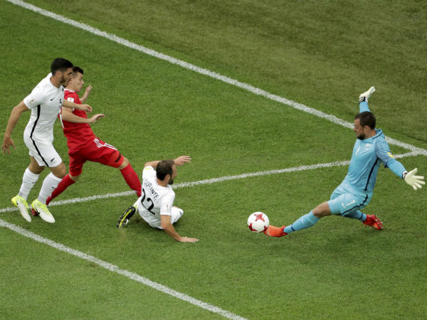 Russia's Dmitry Poloz, 2nd left, challenges New Zealand goalkeeper Stefan Marinovic, right, during the Confederations Cup Russia's Dmitry Poloz, 2nd left, challenges New Zealand goalkeeper Stefan Marinovic, right, during the Confederations Cup