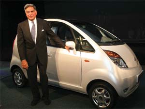 Ratan Tata posing in front of Tata Motors' low-cost car Nano 