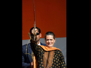 Congress president Sonia Gandhi displays a sword during an election drive in UP