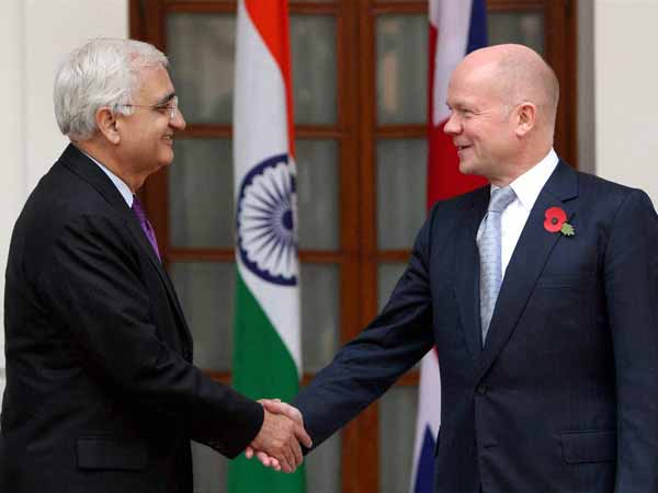 Salman Khurshid shakes and William Hague