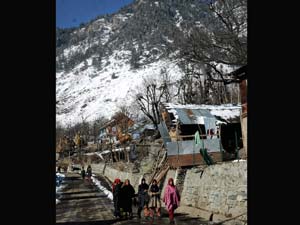 Girls walk towards school at Pahalgam