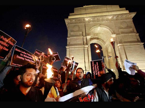 People shout slogans as they stahe a 