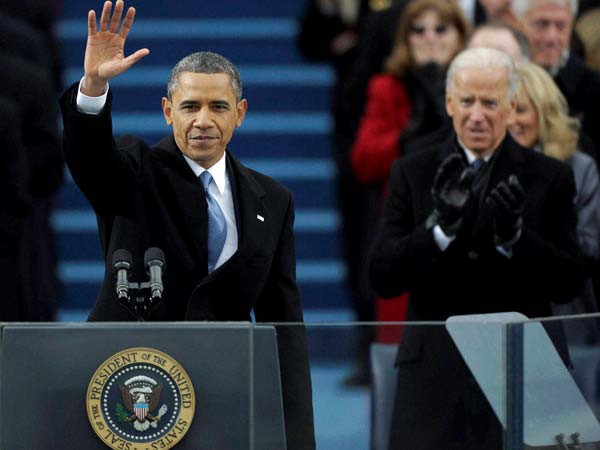 Barack Obama waves after his speech while Vice President Joe Biden applauds