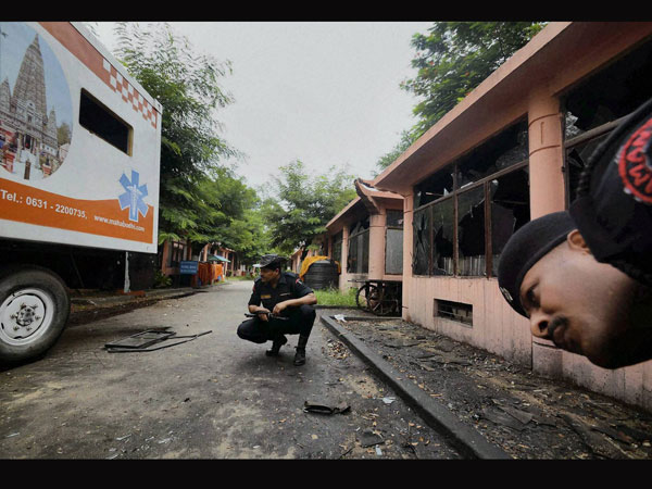 Security personnel inspecting the explosion site