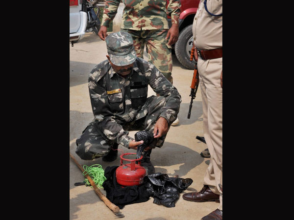Security personnel detonating a cane bomb