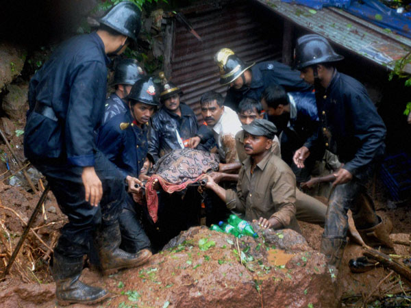 2 dead and 4 trapped in landslide