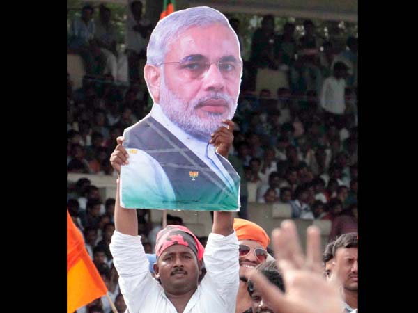 A supporter with a cut-out of Modi