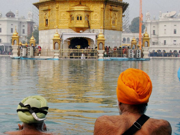 Sikh devotees take bath in the holy sarovar Sikh devotees take bath in the holy sarovar