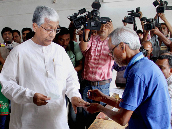 Manik Sarkar gets his finger marked as he arrives to cast his vote