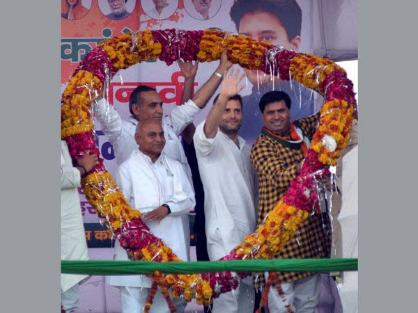 ahul Gandhi being garlanded during an election meeting