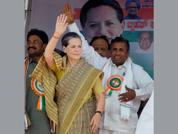 Sonia Gandhi waves to people during an election rally