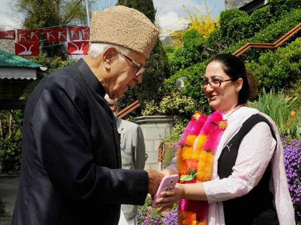 Farooq Abdullah greets a young woman to party in Srinagar