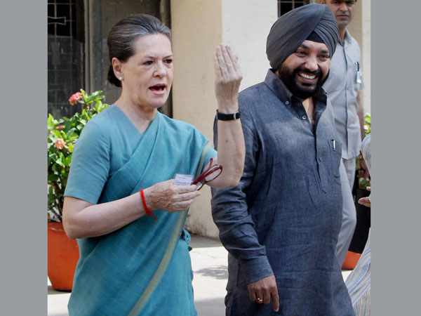 onia Gandhi shows her ink-marked finger after casting vote