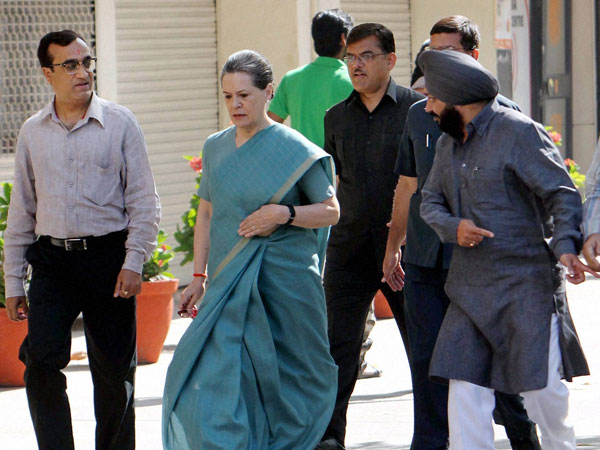 Sonia Gandhi with party candidate Ajay Maken arrives to cast her vote