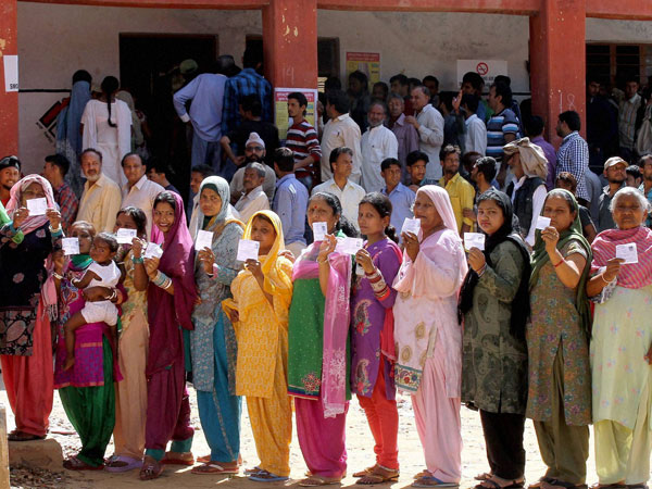 Voters show their ID cards