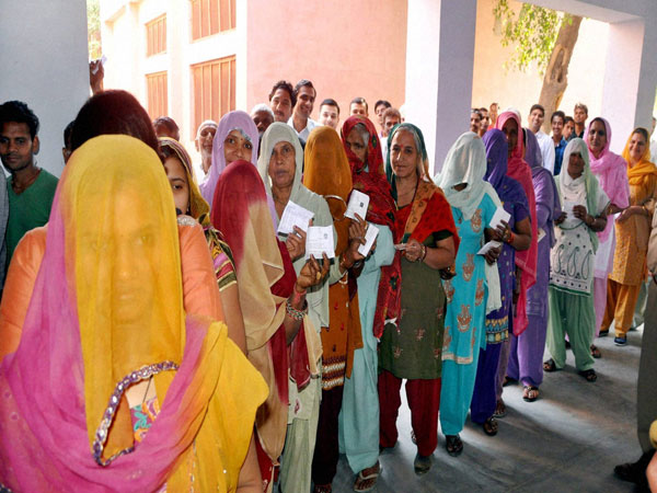 Women show their voting ID card