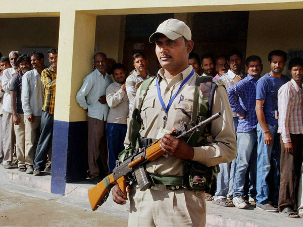 Voter stand in queue to cast their vote at a polling booth