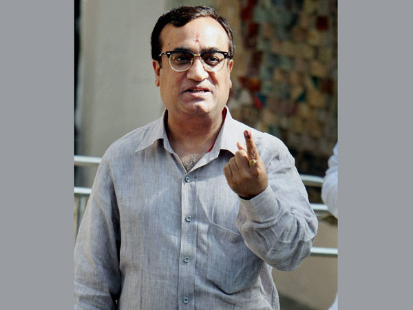Ajay Maken shows his ink-marked finger after casting his vote