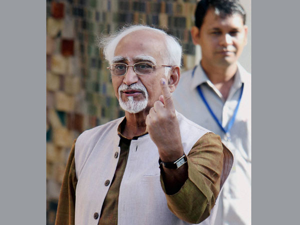 Hamid Ansari shows his ink-marked finger after casting his vote
