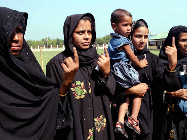 Women voters show their ink marked fingers