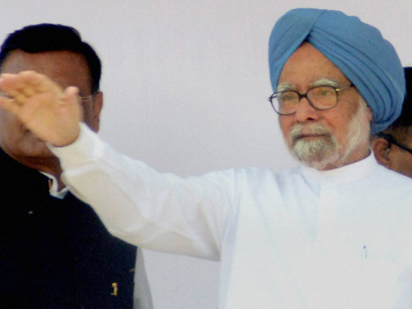 Manmohan Singh waves during an election rally at Puranpur
