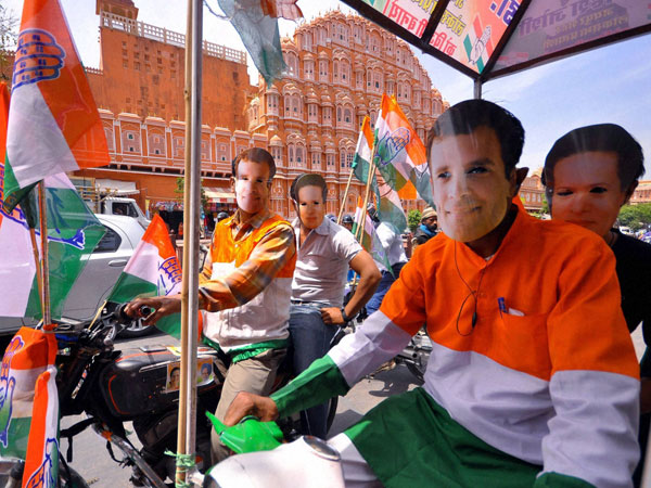 Congress workers wearing masks of party's President Sonia Gandhi and Vice President Rahul Gandhi
