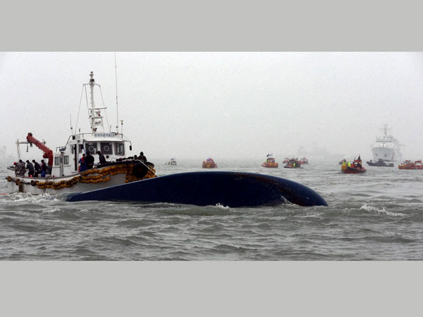 South Korean Coast Guard officers try to search missing passengers