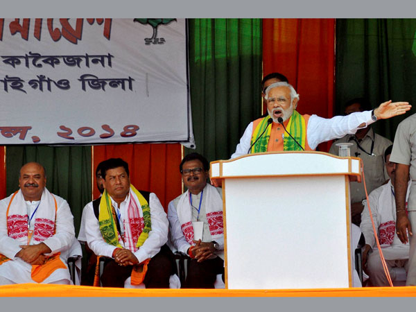 Narendra Modi addresses an election campaign rally at Kakoijan