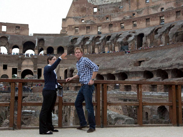 Britain's Prince Harry, right, listens to Italian guide Laura Ciglioni