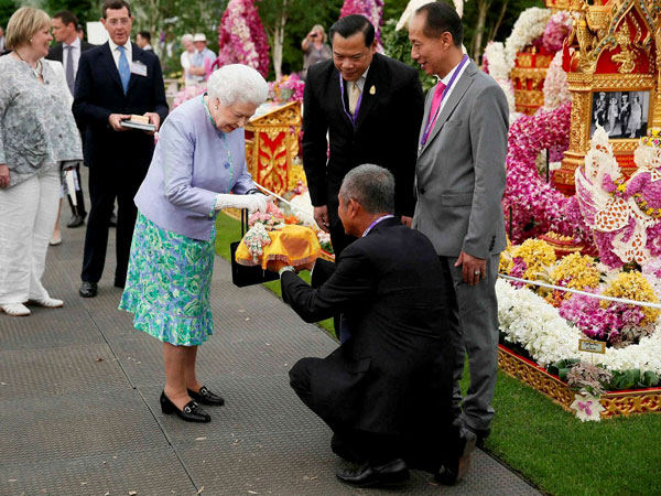 Britain's Queen Elizabeth II, centre, visits the Thai exhibit