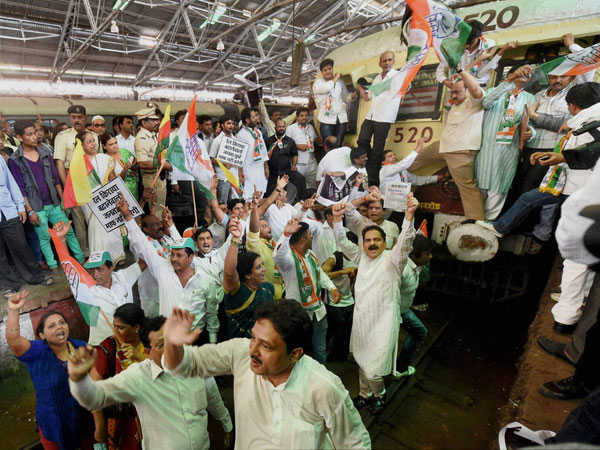 Congress workers stop an express train during a protest