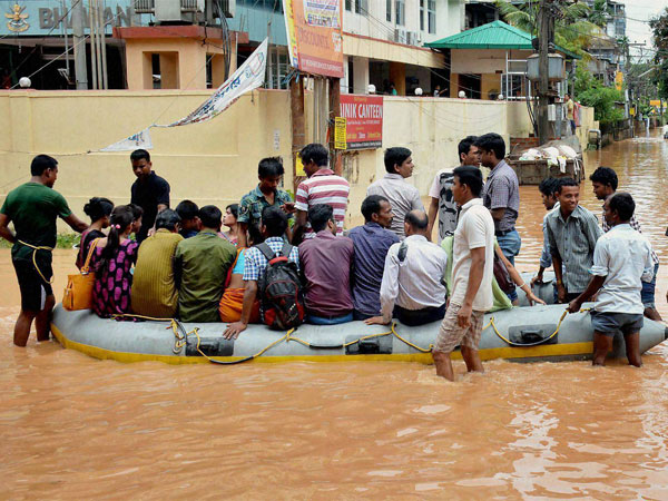 People use rubber boats provided by the district administration