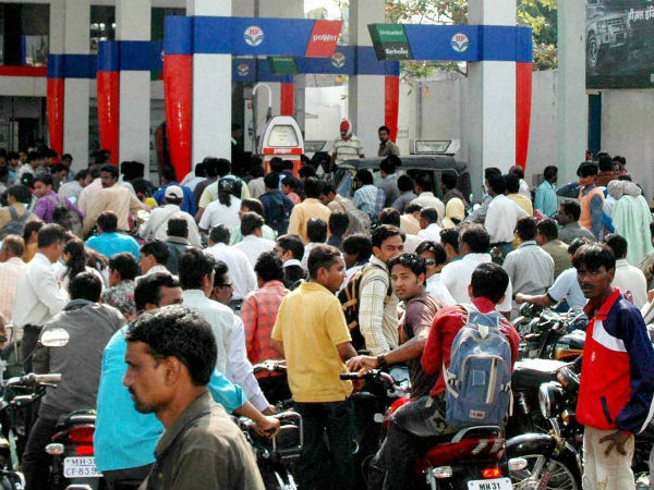 People line up to fill their vehicles at an oil pump in Nagpur after the announcement of hike in petrol prices on Monday. (PTI Photo) 
