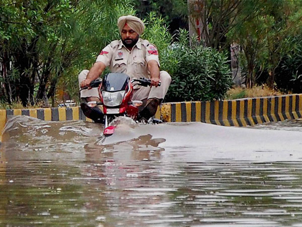 A police officer rides through flooded street A police officer rides through flooded street
