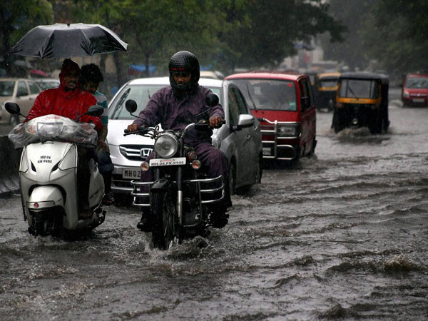 Vehicles move through a waterlogged road Vehicles move through a waterlogged road