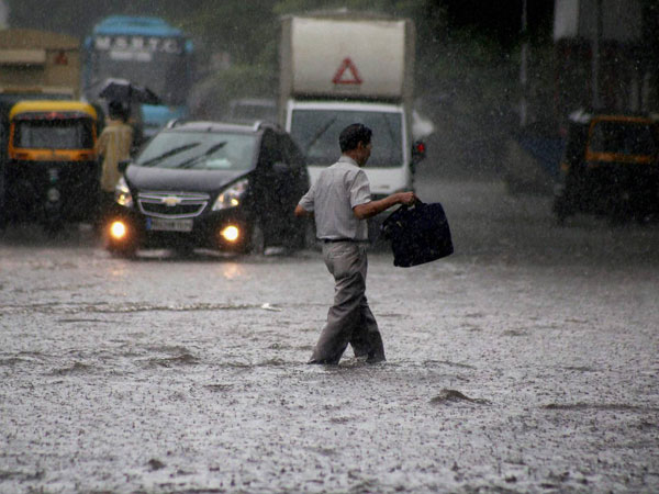 Vehicles move through a waterlogged road Vehicles move through a waterlogged road