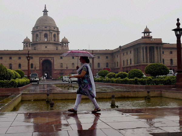 A woman walks with an umbrella as it rains in New Delhi A woman walks with an umbrella as it rains in New Delhi
