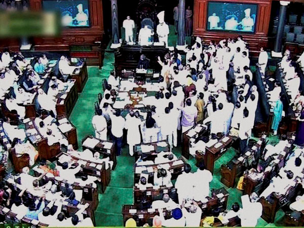 Opposition members raise slogans in the well of the Lok Sabha