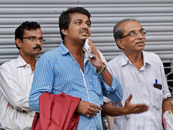 Investors look at the screen outside BSE as the sensex
