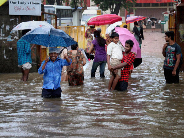 People wading through a waterlogged street