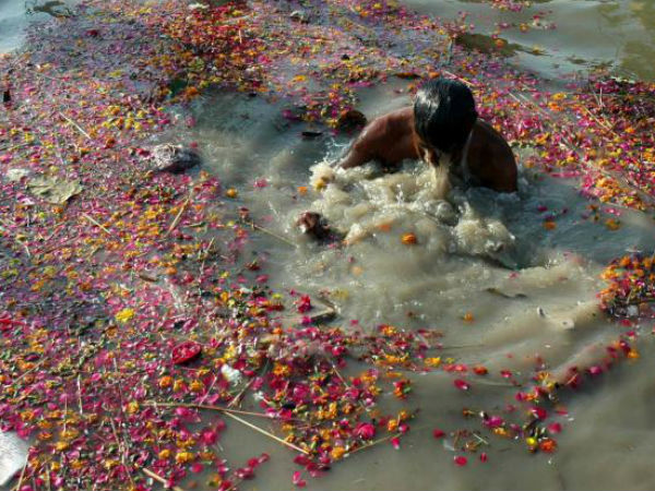 A devotee takes dip in Ganga river at Allahabad.