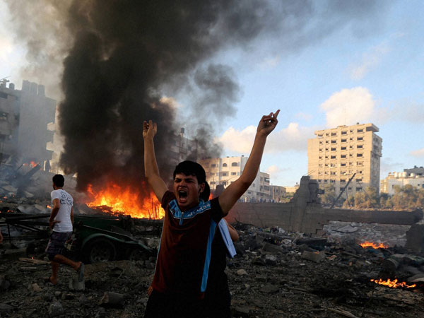 A supporter of Lebanese Christians Phalange party holds up a poster of United Nations Secretary-General Ban Ki-moon during a protest in solidarity with the Christians of Mosul, Iraq, who have fled militants of the Islamic State group, in front the United Nations headquarters, in downtown Beirut, Lebanon, Thursday, July 24, 2014. Most Iraqi Christians have fled Mosul after Islamic extremists gave them a deadline to convert to Islam, pay a tax or face death
