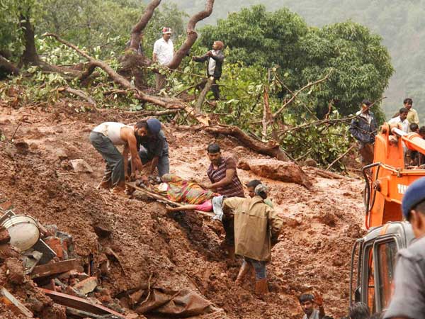 Rescue workers carry the body of a victim at the site