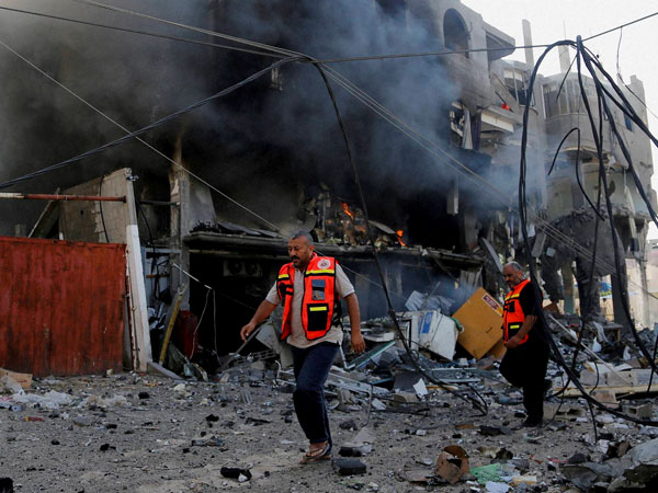 Palestinian firefighters inspects the damage of a destroyed milk factory Palestinian firefighters inspects the damage of a destroyed milk factory